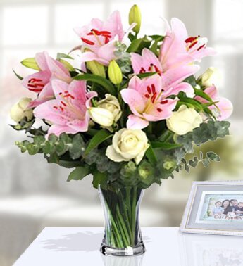 10 Stem of White Roses and 3 Stem of Pink Lilies with fillers in a Glass Vase. Cheery Bouquet
