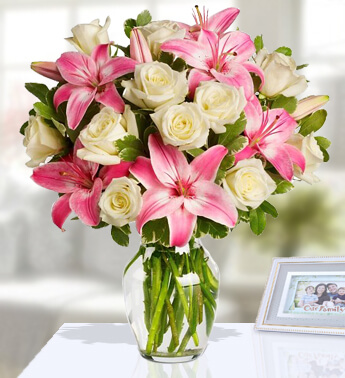 5 Stems of Pink Lilies & 18 Stems of White Roses With Greens in a Glass Vase (one sided round arrangement) Shade Of Pink
