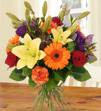 Bunch of 2 Stems Of Yellow Lilies ,3 Stems Of Red Roses ,3 Stems Of Peach Carnations & 3 Stems Of Orange Gerberas with fillers in nice wrapping All For You
