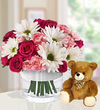 Arrangement of 8 Pink roses, 10 pink carnations and 3 stems of white chrysanthemums in a Glass Vase and a 6'' teddy Blissfull Special
