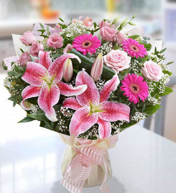 Bunch of 3 stems of Dark Pink Gerbera, 3 stems of Pink Lily, 3 stems of Pink Rose in nice wrapping Contemporary Feel