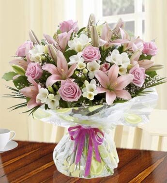 Bunch of 7 stems of Pink Lily and 14 stems of Pink Rose in nice wrapping Ultra-Feminine Bouquet