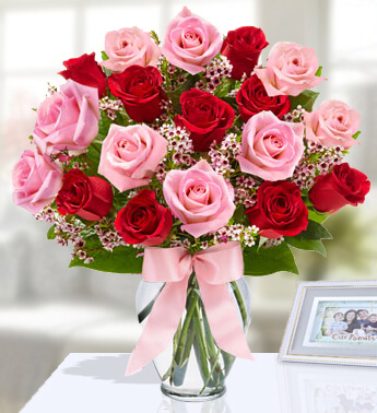 Arrangement of 9 Pink and 9 Red Roses with fillers in a glass vase. (One side round arrangements) Say It With Roses