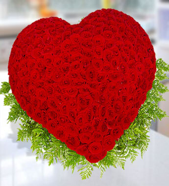 Heart shape arrangement of 200 stems of Red Roses with greens. Heart Of Love