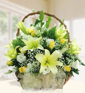 Basket arrangement of 5 stems of White Lilies and 20 Yellow & white Roses with fillers. Basket of love