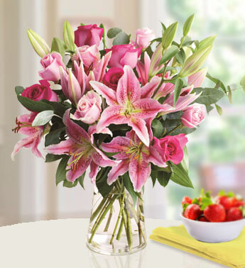 5 stems of Pink Lilies and 12 stems of Pink Rose in a glass vase. Passionate Pink