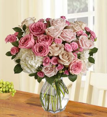 12 Peach Roses, 5 Pink Roses, 25 stems Pink Spray Roses and white Hydrangea in a glass vase. Lady Love
