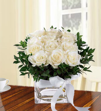 12 White Roses with fillers in a cube vase. Remembrance