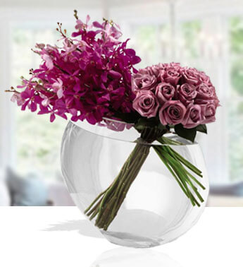 18 Purple Roses and 10 Purple Mokara Orchids in a glass vase. Honorable Purple