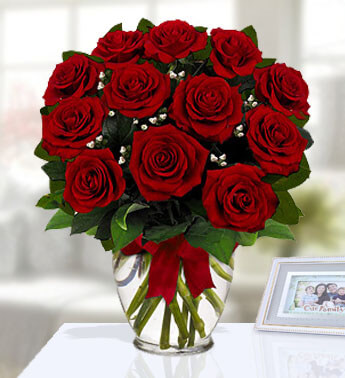 12 Red Roses with fillers in a glass vase. Secret Admirer