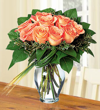 20 Peach Roses with greens in a glass vase. Peachy Roses