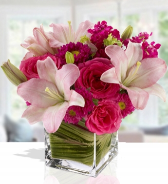 Arrangement of 4 Pink Roses and 2 stems of lilies and 2 stems of pink chrysanthemums in a cube vase Feminine Touch